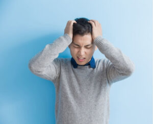 Person experiencing symptoms commonly associated with Vestibular Migraine