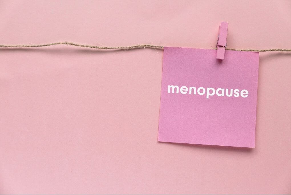 Pink menopause card representing hormonal changes linked with migraine during perimenopause.