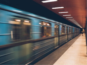 A moving train blurred as it passes through a station, illustrating the type of busy visual motion that may provoke visual motion sensitivity.