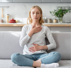 Woman practising breathing techniques to help manage mental health and migraines