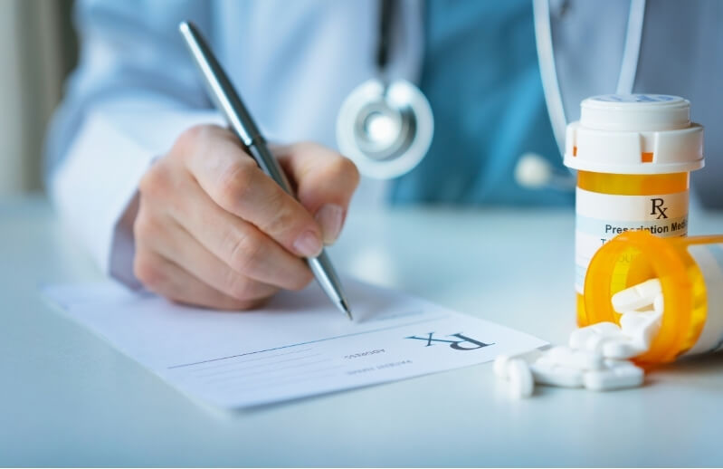 Doctor writes prescription for medication