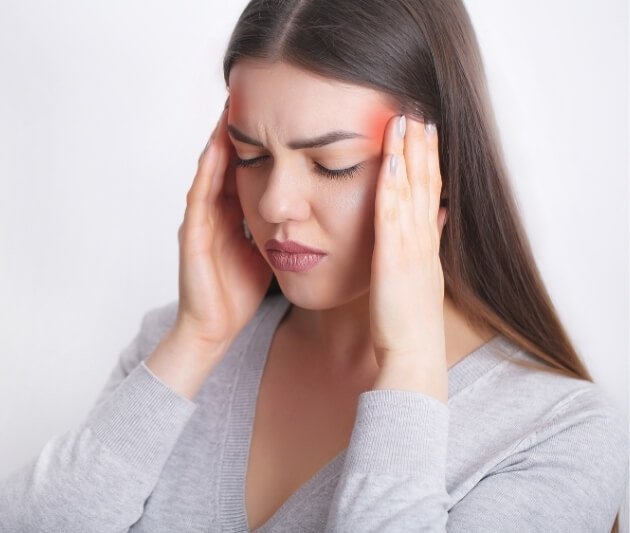 Woman experiencing hormonal headaches during her menstrual cycle.