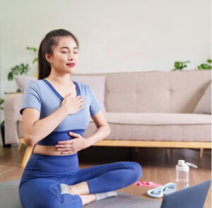 Woman meditating at home for headache relief physiotherapy and stress reduction
