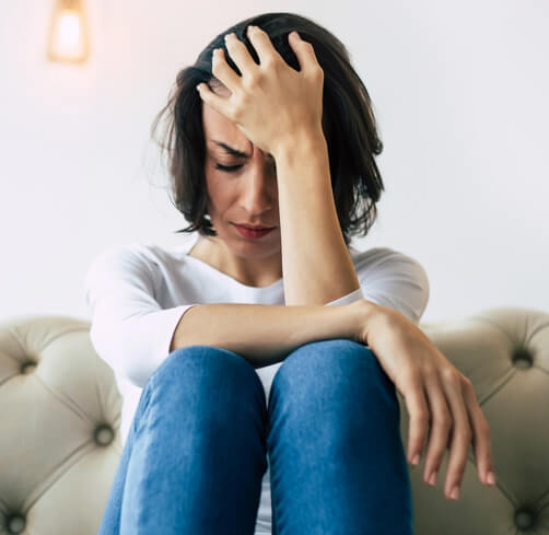 Woman experiencing intense pain from trigeminal autonomic cephalalgias