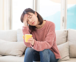 Woman experiencing fatigue linked to REM sleep and headaches